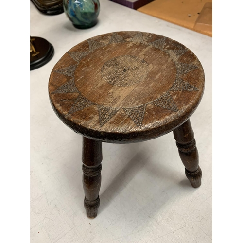 30 - A SMALL MAHOGANY FOUR LEGGED STOOL WITH TEXTURAL DECORATION H: 21CM