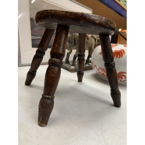 30 - A SMALL MAHOGANY FOUR LEGGED STOOL WITH TEXTURAL DECORATION H: 21CM