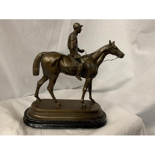 33 - A SPELTER FIGURINE IN THE FORM OF A HORSE AND JOCKEY SIGNED C VALTON