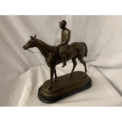 33 - A SPELTER FIGURINE IN THE FORM OF A HORSE AND JOCKEY SIGNED C VALTON