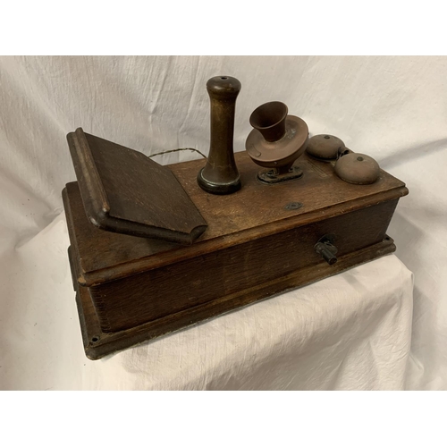 38 - A VINTAGE TELEPHONE WITH DAFFODIL HANDSET AND METAL DOMED BELLS IN AN OAK WALL CASE