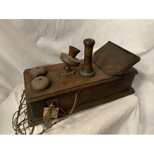 38 - A VINTAGE TELEPHONE WITH DAFFODIL HANDSET AND METAL DOMED BELLS IN AN OAK WALL CASE