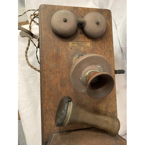 38 - A VINTAGE TELEPHONE WITH DAFFODIL HANDSET AND METAL DOMED BELLS IN AN OAK WALL CASE