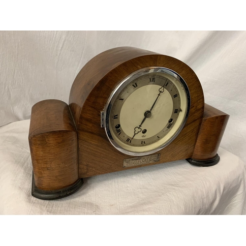 41 - AN ART DECO EIGHT DAY STRIKING WALNUT MANTEL CLOCK WITH PRESENTATION PLAQUE AND KEY