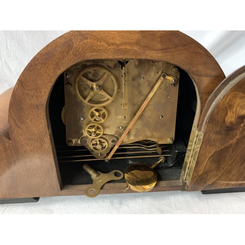 41 - AN ART DECO EIGHT DAY STRIKING WALNUT MANTEL CLOCK WITH PRESENTATION PLAQUE AND KEY