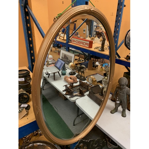 56 - A LARGE OVAL BEVEL EDGE GILT FRAMED MIRROR H: 94CM