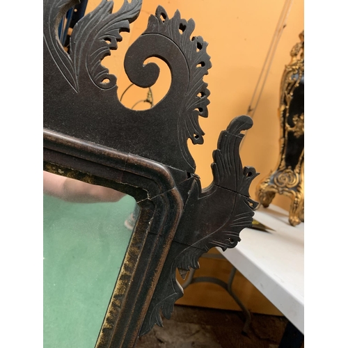 57 - A LARGE MAHOGANY FRAMED MIRROR WITH CARVED DETAIL AND FLEUR DE LIS DECORATION