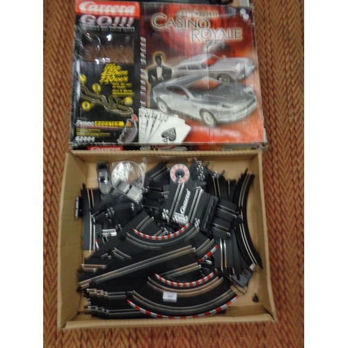 303 - A CARRERA GO111 1:43 SCALE SLOT RACING SYSTEM 'JAMES BOND CASINO ROYALE' AND A BOXED SCALEXTRIC SET