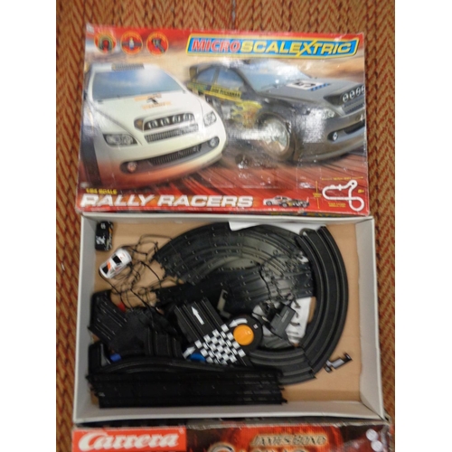 303 - A CARRERA GO111 1:43 SCALE SLOT RACING SYSTEM 'JAMES BOND CASINO ROYALE' AND A BOXED SCALEXTRIC SET