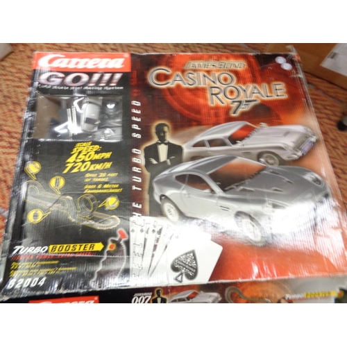 303 - A CARRERA GO111 1:43 SCALE SLOT RACING SYSTEM 'JAMES BOND CASINO ROYALE' AND A BOXED SCALEXTRIC SET