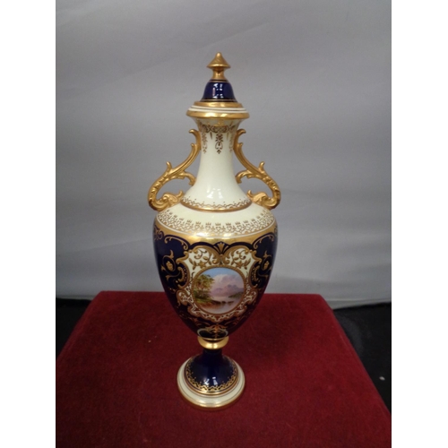 752 - TWO ORNATE LIDDED URNS WITH DARK BLUE AND GILT DECORATION A/F HAIRLINE CRACK ON SMALLER URN