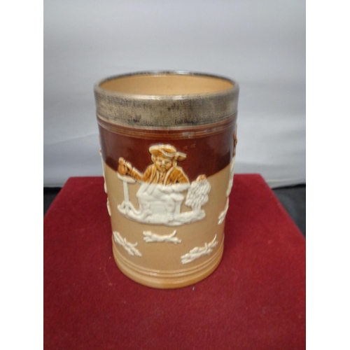 763 - A LAMBETH WARE TANKARD WITH A HALLMARKED LONDON SILVER RIM