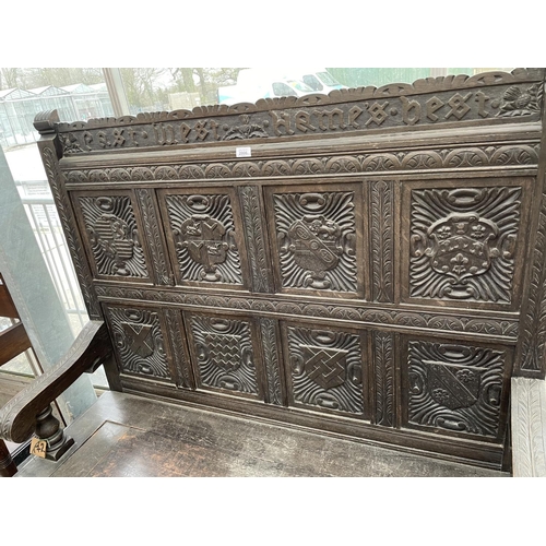 2006 - A VICTORIAN OAK SETTLE WITH TWELVE CARVED PANELS DEPICTING VARIOUS CRESTS AND MOTTO 'EAST, WEST, HOM... 