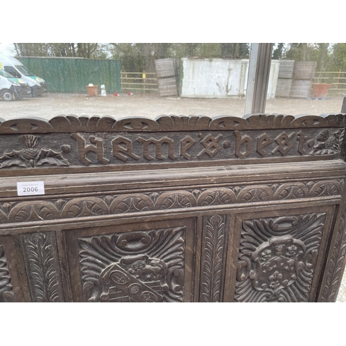 2006 - A VICTORIAN OAK SETTLE WITH TWELVE CARVED PANELS DEPICTING VARIOUS CRESTS AND MOTTO 'EAST, WEST, HOM... 