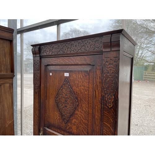 2009 - AN EARLY 20TH CENTURY OAK HALL WARDROBE WITH PANELED DOOR AND INTERNAL MIRROR, 30