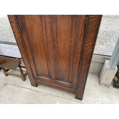 2009 - AN EARLY 20TH CENTURY OAK HALL WARDROBE WITH PANELED DOOR AND INTERNAL MIRROR, 30