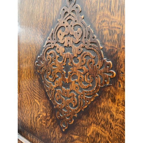 2009 - AN EARLY 20TH CENTURY OAK HALL WARDROBE WITH PANELED DOOR AND INTERNAL MIRROR, 30