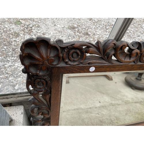 2010 - A HEAVILY CARVED OAK JACOBEAN STYLE WALL MIRROR WITH BEVEL EDGE, 51