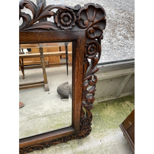 2010 - A HEAVILY CARVED OAK JACOBEAN STYLE WALL MIRROR WITH BEVEL EDGE, 51