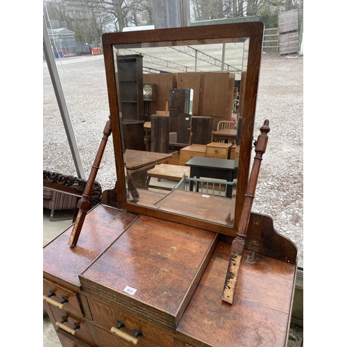 2012 - AN EARLY 20TH CENTURY OAK DRESSING CHEST ENCLOSING NINE DRAWERS