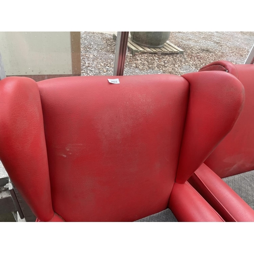 2023 - A PAIR OF RED LEATHERETTE PARKER KNOLL STYLE WINGED FIRESIDE CHAIRS