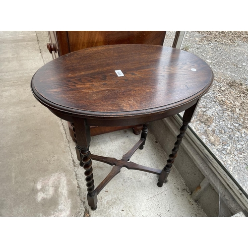 2028 - AN OVAL EALRY 20TH CENTURY OAK CENTRE TABLE ON BARLEYTWIST LEGS AND SMALL OAK OCCASIONAL TABLE