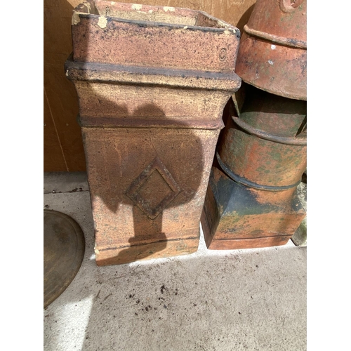 1253 - A PAIR OF DECORATIVE CHIMNEY POTS