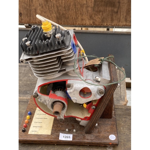 1265 - A MODEL OF A FOUR STROKE ENGINE ON A WOODEN PLINTH