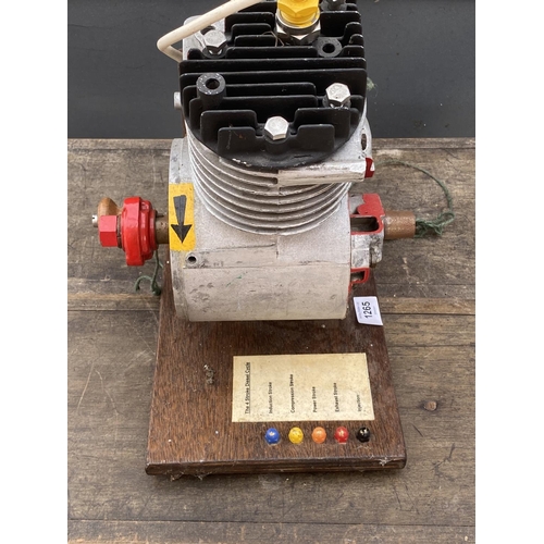 1265 - A MODEL OF A FOUR STROKE ENGINE ON A WOODEN PLINTH