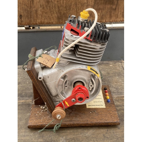 1265 - A MODEL OF A FOUR STROKE ENGINE ON A WOODEN PLINTH