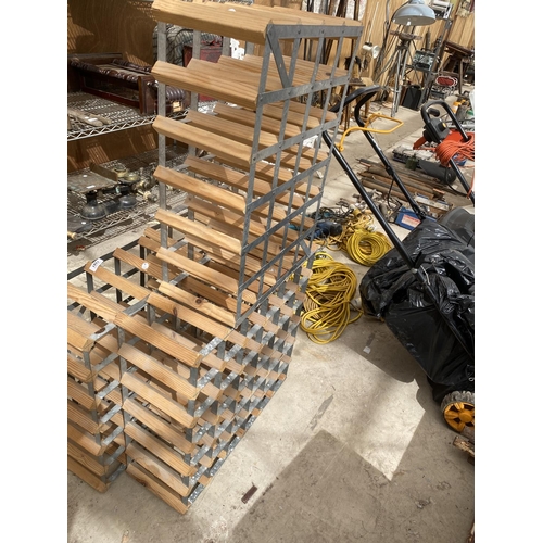 1281 - A SET OF FOUR STACKING METAL AND WOODEN WINE RACKS