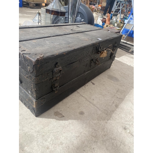 1384 - A LARGE VINTAGE TRUNK WITH WOOD BINDING