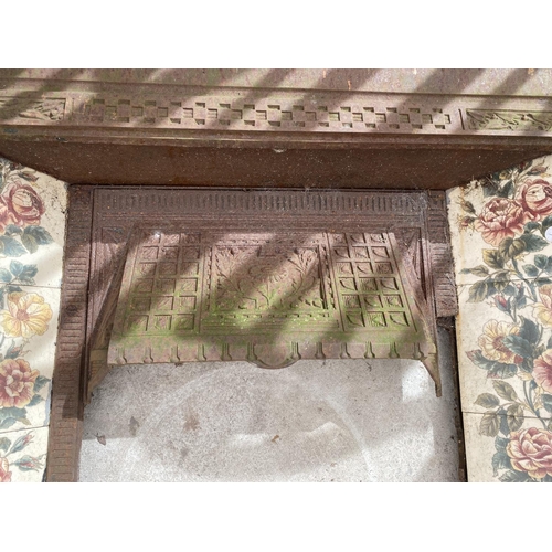 1490 - A CAST IRON AND TILED DECORATIVE FIRE SURROUND