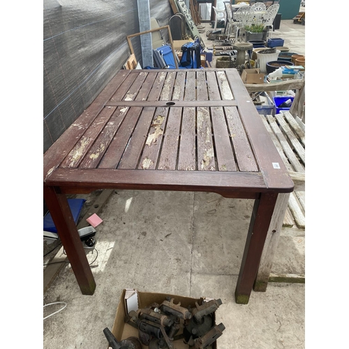 1597 - A RECTANGULAR TEAK TABLE AND A WOODEN SLATTED GARDEN BENCH