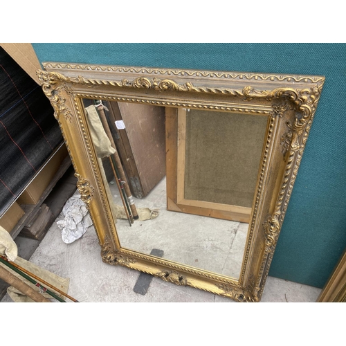 1610 - A DECORATIVE GILT FRAMED MIRROR AND A FURTHER DECORATIVE WOODEN FRAMED MIRROR