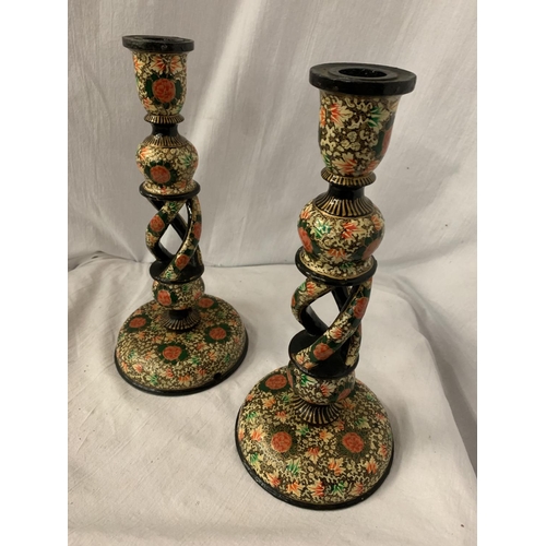 111 - A PAIR OF DECORATIVE WOODEN CANDLESTICKS IN THE WILLIAM MORRIS STYLE H: 32CM