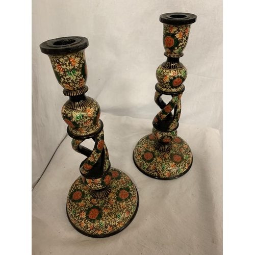 111 - A PAIR OF DECORATIVE WOODEN CANDLESTICKS IN THE WILLIAM MORRIS STYLE H: 32CM