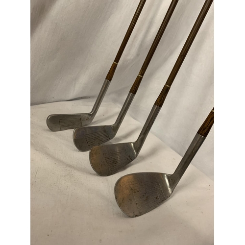 125 - FOUR VINTAGE GOLF CLUBS