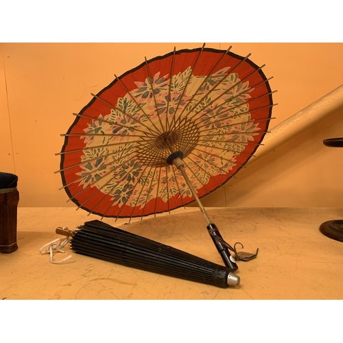 128 - A PAIR OF ORIENTAL PAPER PARASOLS