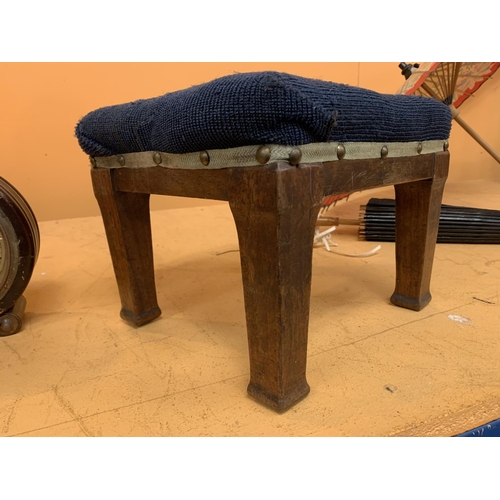 129 - A SMALL FOUR LEGGED BLUE UPHOLSTERED FOOTSTOOL