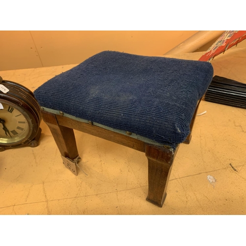 129 - A SMALL FOUR LEGGED BLUE UPHOLSTERED FOOTSTOOL