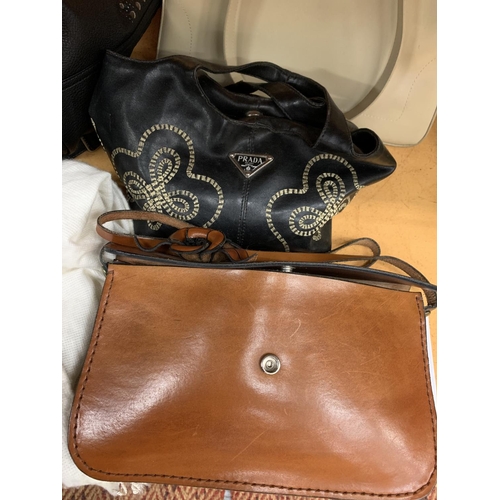 135 - A COLLECTION OF DESIGNER HANDBAGS TO INCLUDE   PRADA, OSPREY, RALPH LAUREN ETC