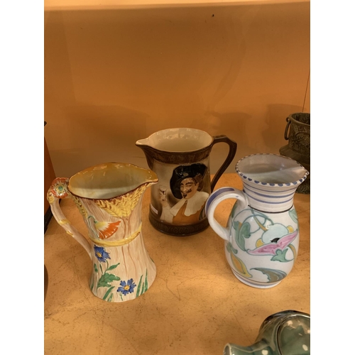 140 - A COLLECTION OF CERAMIC JUGS TO INCLUDE A TEA POT AND A CHARACTER JUG