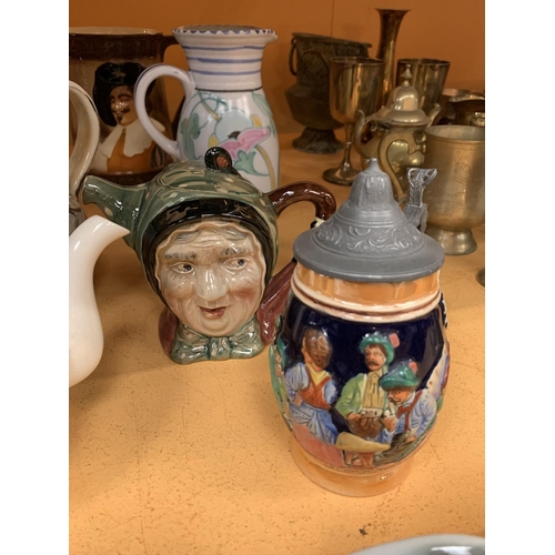 140 - A COLLECTION OF CERAMIC JUGS TO INCLUDE A TEA POT AND A CHARACTER JUG