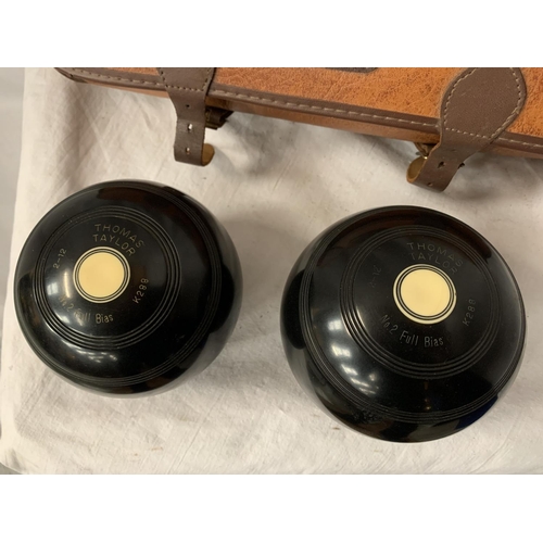 176 - A LEATHER 'MITRE' CASE CONTAINING A PAIR OF BOWLS