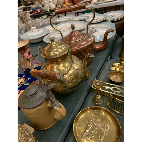 82 - A LARGE QUANTITY OF BRASS AND COPPER WARE TO INCLUDE KETTLES, DISHES, A BRASS DECORATIVE OVAL HINGE ... 