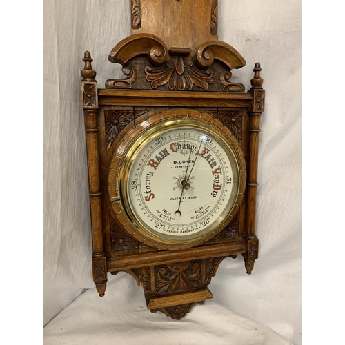 86 - A LARGE ORNATE OAK BAROMETER 'D COHEN JEWELLERS, ALDERLEY EDGE' (MISSING THERMOMETER) L: 95CM