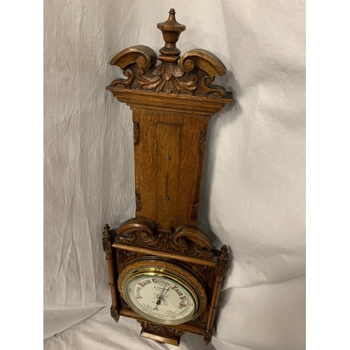 86 - A LARGE ORNATE OAK BAROMETER 'D COHEN JEWELLERS, ALDERLEY EDGE' (MISSING THERMOMETER) L: 95CM