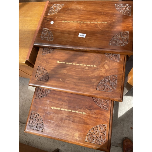 2066 - A NEST OF THREE ASIAN HARDWOOD TABLES WITH CARVING AND INLAY TO THE TOP