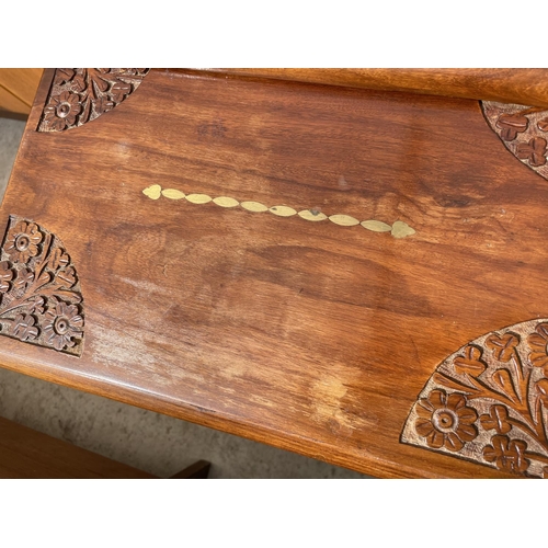 2066 - A NEST OF THREE ASIAN HARDWOOD TABLES WITH CARVING AND INLAY TO THE TOP